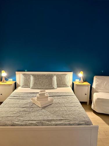 a bedroom with a bed with a blue wall at Romulea Guest House in Rome