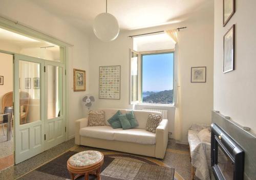 a living room with a couch and a window at Andromeda Flexyrent in Rapallo