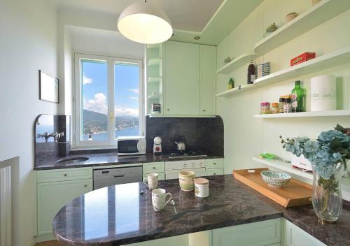 a kitchen with a table and a window at Andromeda Flexyrent in Rapallo