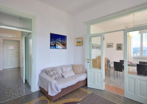 a living room with a bed and a dining room at Andromeda Flexyrent in Rapallo