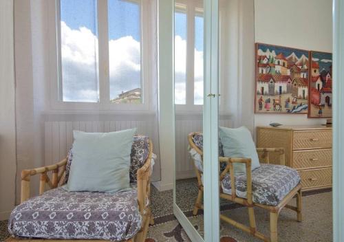 a living room with a chair and a mirror at Andromeda Flexyrent in Rapallo