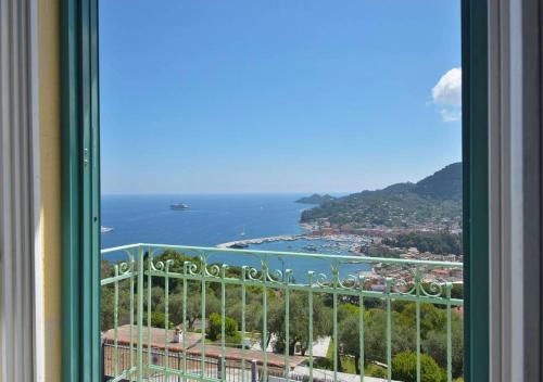 a window with a view of the ocean and a city at Andromeda Flexyrent in Rapallo