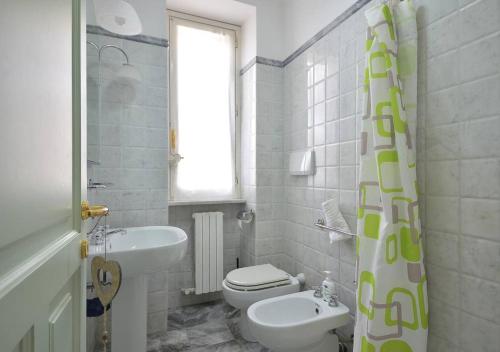 a bathroom with a sink and a toilet and a window at Andromeda Flexyrent in Rapallo