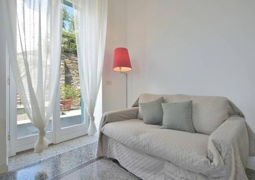 a living room with a couch and a window at Andromeda Flexyrent in Rapallo