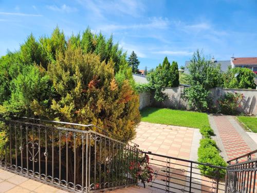 a view of a garden with a fence at Radio Hotel Bratislava in Trnávka