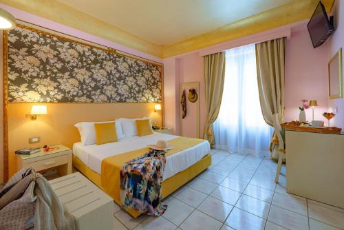 a hotel room with a bed and a window at Fazio Rooms in Sciacca