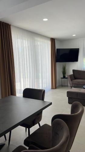 a living room with a table and chairs and a couch at Luxury Villa Mojito in Široki Brijeg
