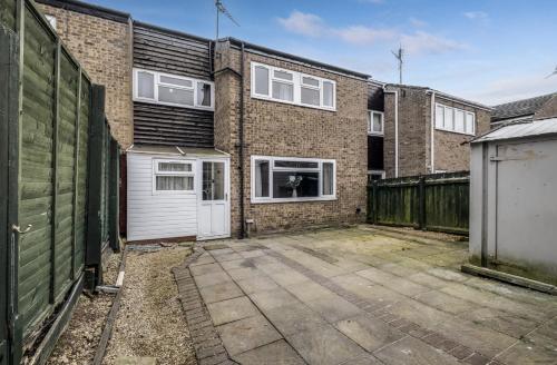 an empty parking lot in front of a brick building at Spacious 4 Bedroom House private parking in Cottingham