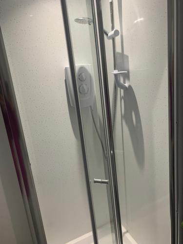 a glass door of a shower stall with a door at Ocean Bay in Blackpool