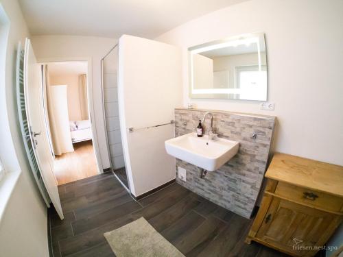 a bathroom with a sink and a mirror at friesen-nest-spo in Böhl