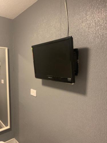 a flat screen tv hanging on a wall at Ocean Bay in Blackpool