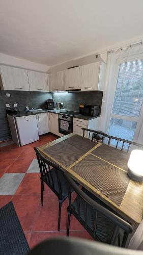 a kitchen with a table and chairs and a table and a kitchen at Chata Filoména in Herálec
