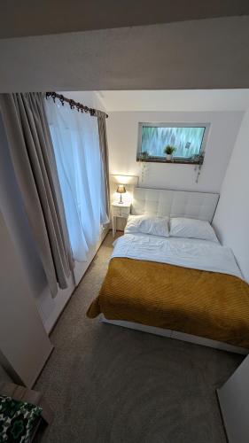 a bedroom with a large bed and a window at Chata Filoména in Herálec