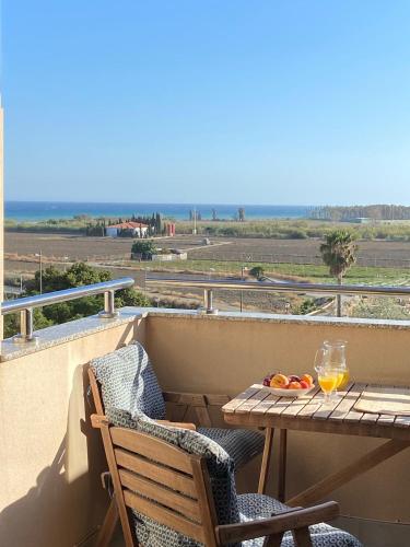 a table and chairs on a balcony with a view of the ocean at LA MARINA in Torre del Mar
