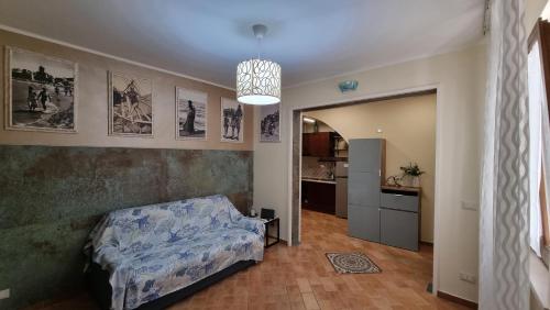 a living room with a bed and a kitchen at Dimora Sogno Suite in Termoli