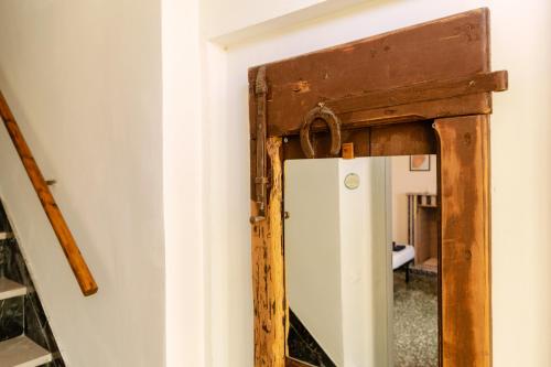 an old mirror in a room with a refrigerator at B&B La Ciammaruca in Pollutri