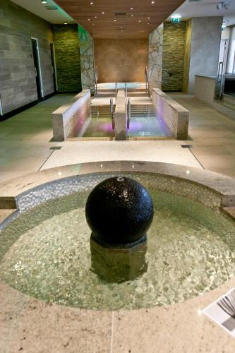 a pool of water with a black ball in it at WestCord Strandhotel Seeduyn in Oost-Vlieland