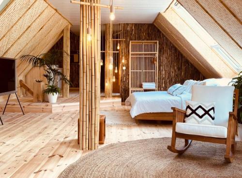 a bedroom with a bed and a tv in a attic at Buddhas Bed & Wellness - Retreat - FEEL GOOD FOOD - B&B- mit viel Herz für Körper Geist & Seele in Tosterglope