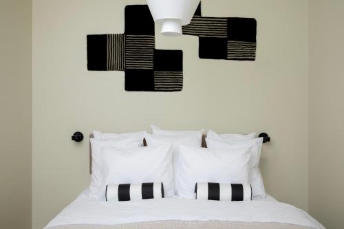 a bedroom with a bed with black and white pillows at Bob W Turku City Centre in Turku