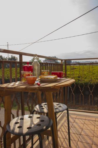 a wooden table with two chairs and a table with food on it at B&B La Ciammaruca in Pollutri