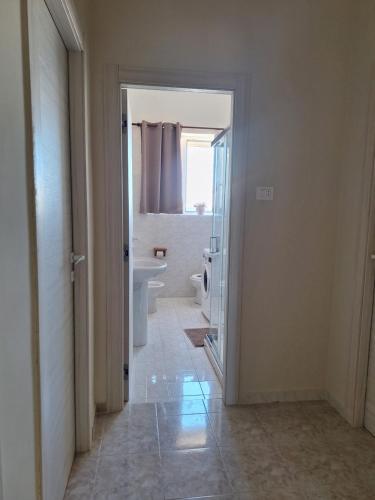 a white bathroom with a toilet and a sink at Casa Dolce Casa in Termoli
