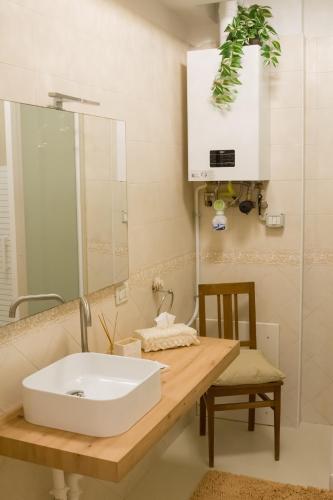 a bathroom with a sink and a mirror at Collio Suite in Cormòns