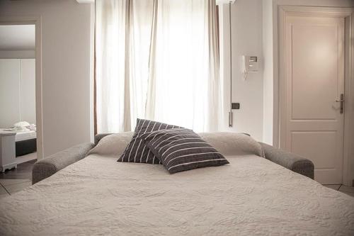 a bed with a pillow on it in a room at Lido Camaiore - Appartamento Il Pinolo in Camaiore