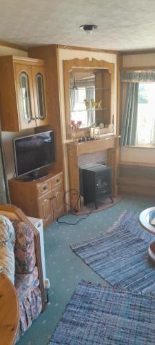 a living room with a flat screen tv and a couch at Bermudi in Dobele