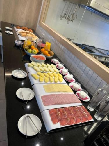 a buffet line with many different types of food at Iraipe Logroño Hotel in Logroño