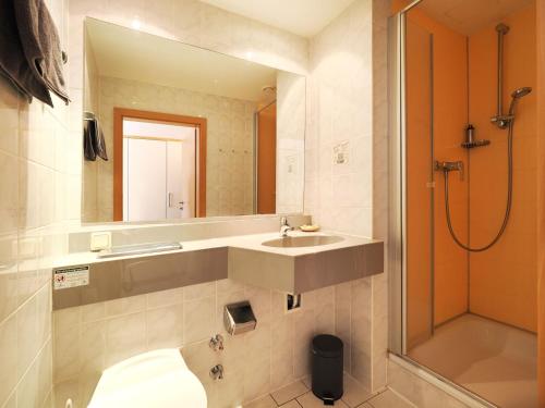 a bathroom with a sink and a shower at Forsthaus Langenberg in Bansin