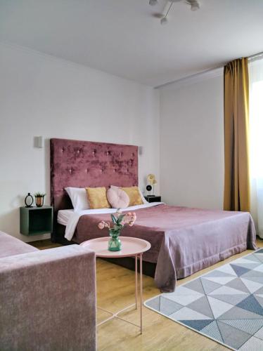 a hotel room with two beds and a table at Best One Room Apartments in Mukacheve