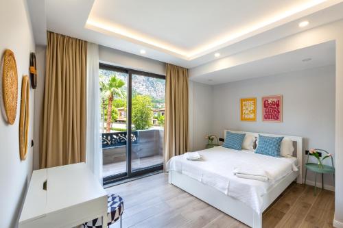 a bedroom with a bed and a large window at Villa Palmiye by Villa Safiya in Göcek