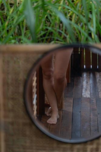 a reflection of a babies legs in a mirror at Calidas Hill in Kintamani