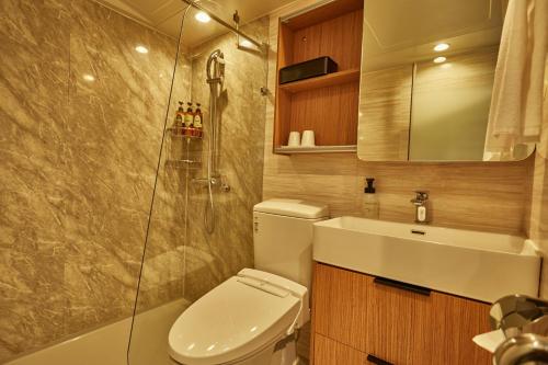 a bathroom with a toilet and a sink and a shower at EZ HOTEL Kansai Airport Seaside in Izumi-Sano