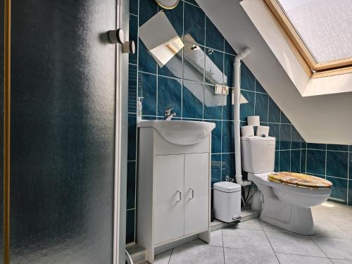 a bathroom with a toilet and a sink at Pokoje u Marii in Międzyzdroje