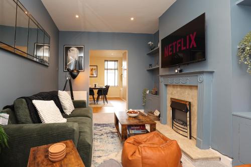 a living room with a couch and a fireplace at Elmbank House in New Ferry