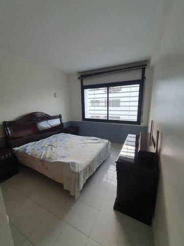 un dormitorio con una cama y una ventana en Luxueux Appartement 3 Chambres, en Rabat
