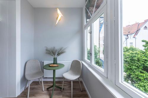 a room with a table and two chairs and a window at Lapwing Nest in Sopot