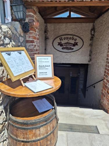 a table on top of a barrel with a laptop on it at Bracera Inn in Malinska