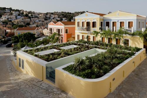 a house with a garden on top of it at Opera House Hotel in Symi