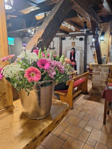 a vase filled with flowers sitting on a table at Bracera Inn in Malinska