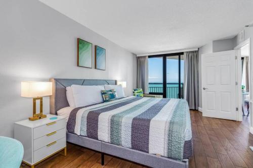 a bedroom with a bed with a view of the ocean at Pristine Oceanfront King Suite Best Layout in Bldg 806 in Myrtle Beach