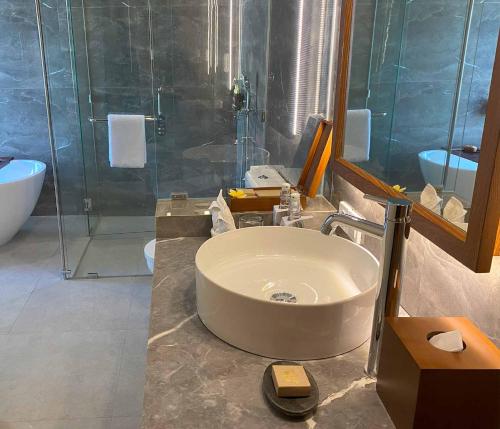 a bathroom with a sink and a shower at The Prime Canggu Bali by Kanaya Hospitality in Canggu
