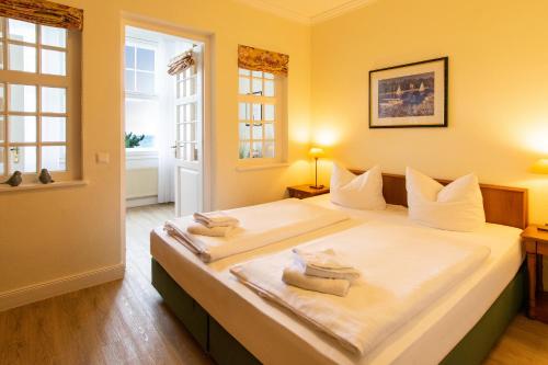 a bedroom with a large bed with two towels on it at Seehof Seehof 23 in Bansin
