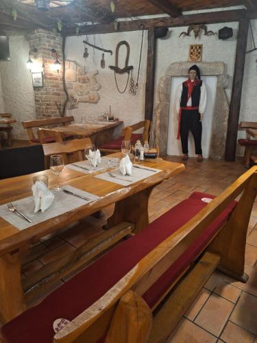 a man standing in a room with a table in a restaurant at Bracera Inn in Malinska