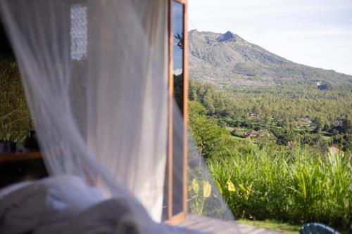 a window with a view of a mountain at Calidas Hill in Kintamani