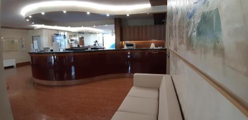 a living room with a couch and a bar at Residence all'Adige in Verona