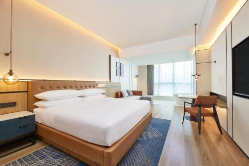 a hotel room with a bed and a television at Four Points by Sheraton Chengdu, High-Tech Zone Exhibition Center in Chengdu