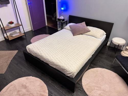 a bedroom with a bed with pillows and rugs at Chambre Neptune in Brussels