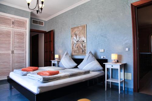 a bedroom with a large bed with pillows on it at Finca Leilani in Llucmajor